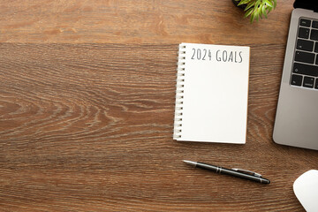 Notebook with 2024 goals text on it to apply new year resolutions and plan.