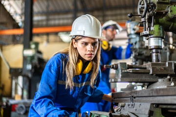 Professional machanic engineer technician industrial woman wearing safety uniform working control...