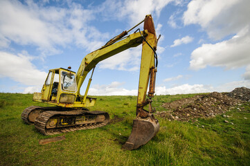 Hymac 580 tracked excavator digger in a rural farm field.