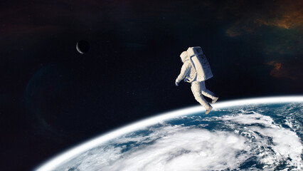 Astronaut on low-orbit of Earth planet. Elements of this image furnished by NASA.