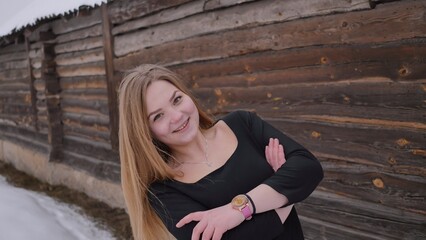 Fototapeta premium A young schoolgirl with no cues poses in winter.