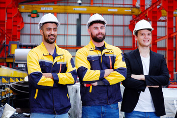Obraz premium Engineer wearing safety helmet standing smiling in factory industrial factory concept.