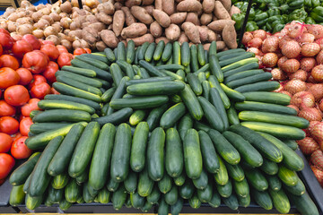 Cucumber and vegetable display in supermarket. 