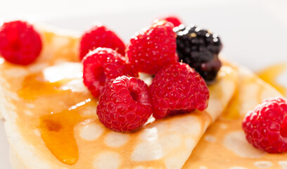 Pancakes with raspberries, blackberries and honey