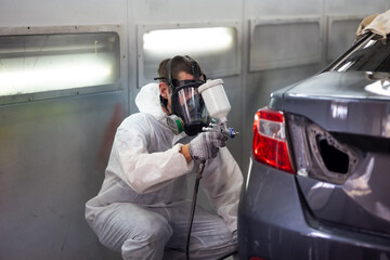 Auto mechanic car hispanic man worker working painting in car paint chamber. Body paint garage....