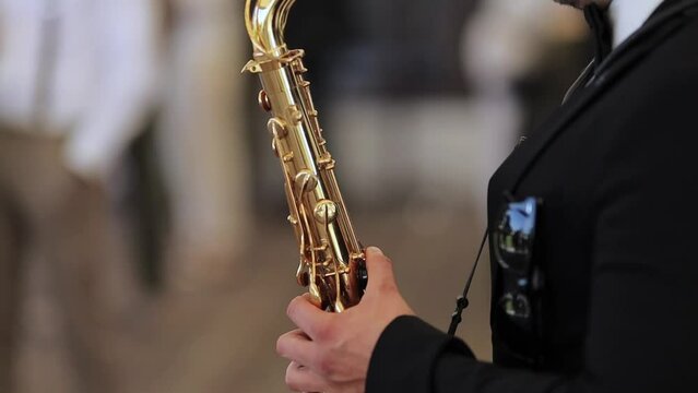 Saxophonist musician playing saxophone or sax at the concert or party. Saxophonist live performance. Saxophonist play on golden saxophone, close up. Jazz music. horizontal orientation video