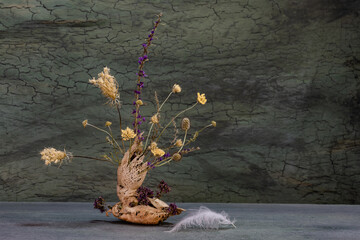 Ikebana of autumn flowers. Bonsai in a walnut shell.