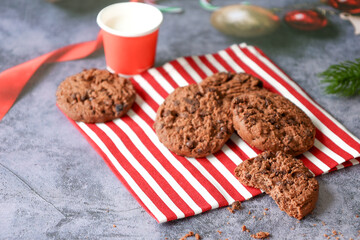 Milk and chocolate biscuits for Santa, placed on a red towel.