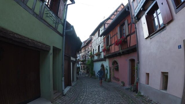 Moving through the colorful half timbered building in the streets of the beautiful Alsace village Riquewihr