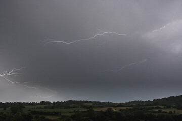 Lightning bolt on the dark cloudy sky