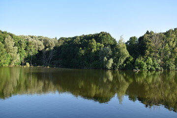 Fototapeta premium Natural reflections, mirror effect on water, lake in Poltava region, Ukraine