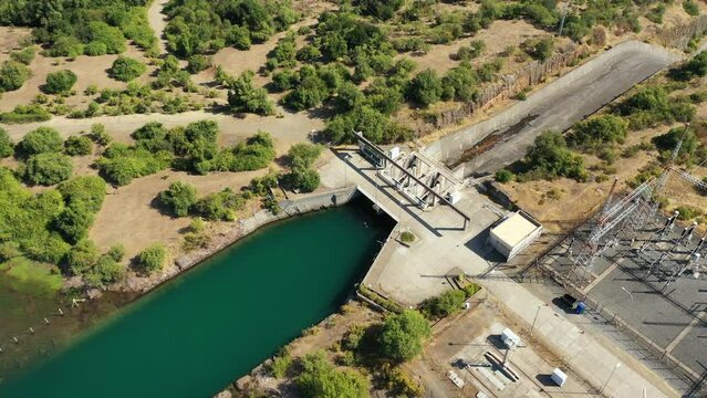 Aerial view of hydro power plant damb with water passing through it in Chile.