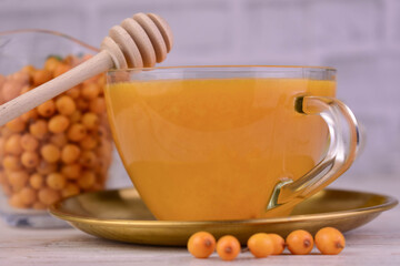 Tea from sea buckthorn berries in a cup. Close-up.	