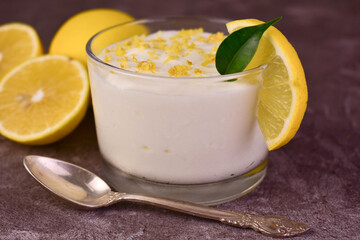Sweet and sour creamy lemon dessert in glasses. Close-up.