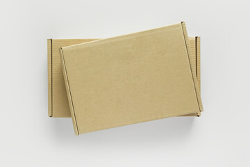 two different cardboard boxes on a white table, top view. parcels, packaging, mail concept