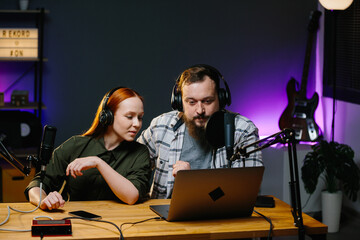 A couple of bloggers in a home studio broadcasting a live video. Record an interview or podcast.