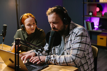 The radio host reads listeners' questions to the studio guest. Online media concept.
