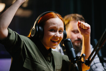 Cheerful positive radio host of the evening broadcast, posing for the camera.
