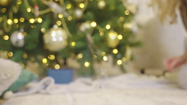 Woman decorating Christmas tree, blurred christmas background video