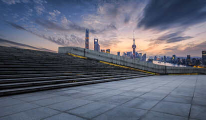 Fototapeta na wymiar Square floor and city buildings skyline in Shanghai at sunset