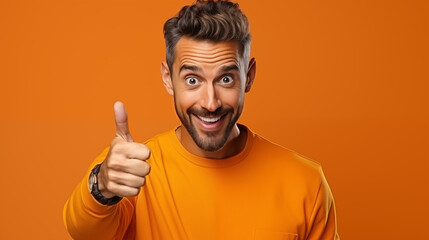 A man in an orange wear on an orange background. He was showing a thumb signal with his hand. copy space for text.