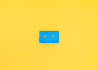 Blue cassette tape on yellow background