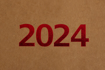 year 2024 red numbers with kraft paper background, recycling craft texture