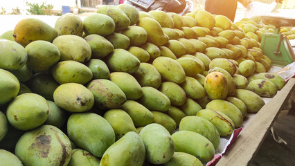 Indramayu mango seller, Indonesia on the side of the road, piles of green mangoes arranged neatly.outdoor