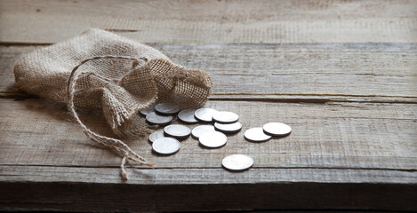 Thirty coins in a bag on the table - obrazy, fototapety, plakaty