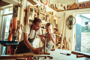 Father and Child Enjoying Woodworking Together in a Workshop