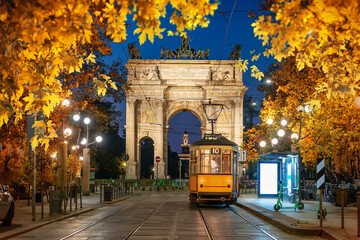 Arch and yellow tram in autumn - obrazy, fototapety, plakaty