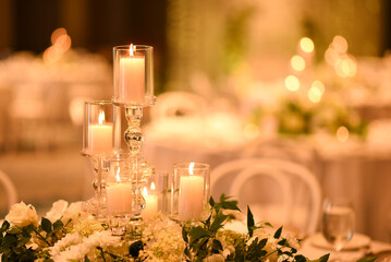 Close up of wedding table candles with flower decorations
