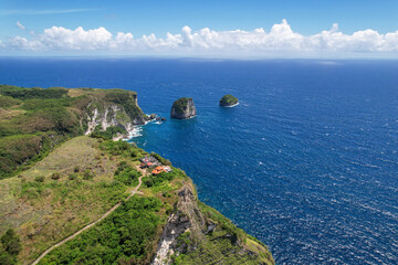 Aerial view of Manta Cliff, Manta Point and Pura Segara hindu temple on sunny day. Nusa Penida Island, Indonesia.