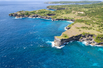 Aerial view of Dolphin Bay; Broken Beach and Angel's Billabong on sunny day. Nusa Penida Island, Indonesia.