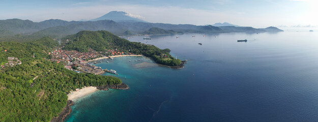 Panoramic drone view of Bias Tugel Beach, Padangbai bay and Mount Agung on sunny day. Manggis,...