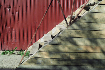 A wooden staircase with railings is covered with boards,