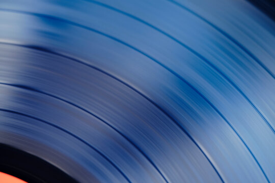 Sound tracks on a vinyl blue record closeup macro photo.