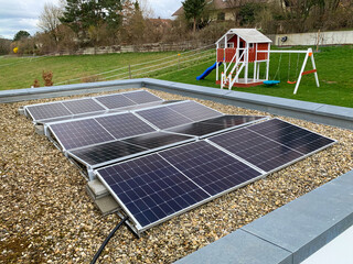 Solar panels on the rooftop of a house, using renewable energy in modern buildings