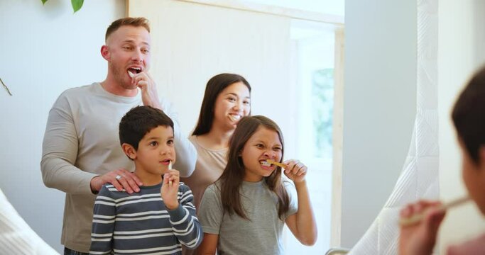 Happy family, brushing teeth and morning routine in mirror, reflection and bathroom for hygiene and wellness. Dental care, oral health and toothbrush with toothpaste, gum disease, cleaning mouth