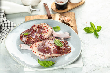 Raw meat, duck legs on a light background top view. copy space