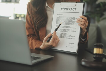 Business and lawyers discussing contract papers with brass scale on desk in office. Law, legal...