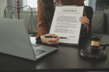 Business and lawyers discussing contract papers with brass scale on desk in office. Law, legal...