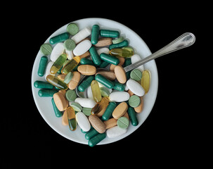 assorted tablets for food on a plate with a spoon