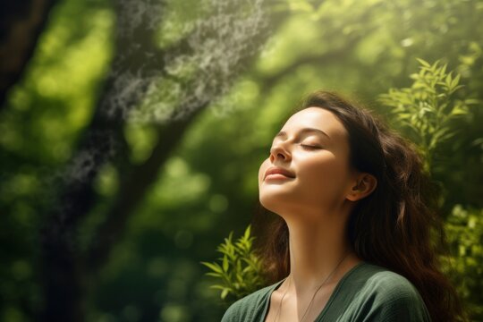Young woman breathing clean fresh air in forest