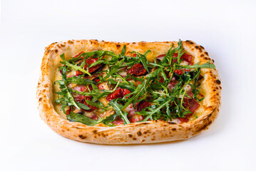 pizza with smoked beef, dried tomatoes, mushrooms and arugula on a white background