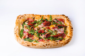 pizza with smoked beef, dried tomatoes, mushrooms and arugula on a white background