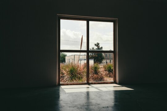 Empty loft interior of a building with a view of the city of Marfa, Texas