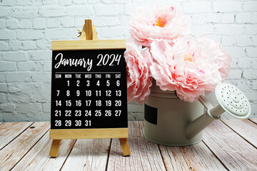 January 2024 monthly calendar with flower bouquet decoration on wooden background