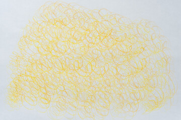 circular or cursive pattern in yellow on blank paper