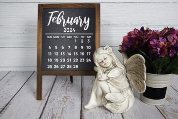 February 2024 monthly calendar with flower bouquet decoration on wooden background